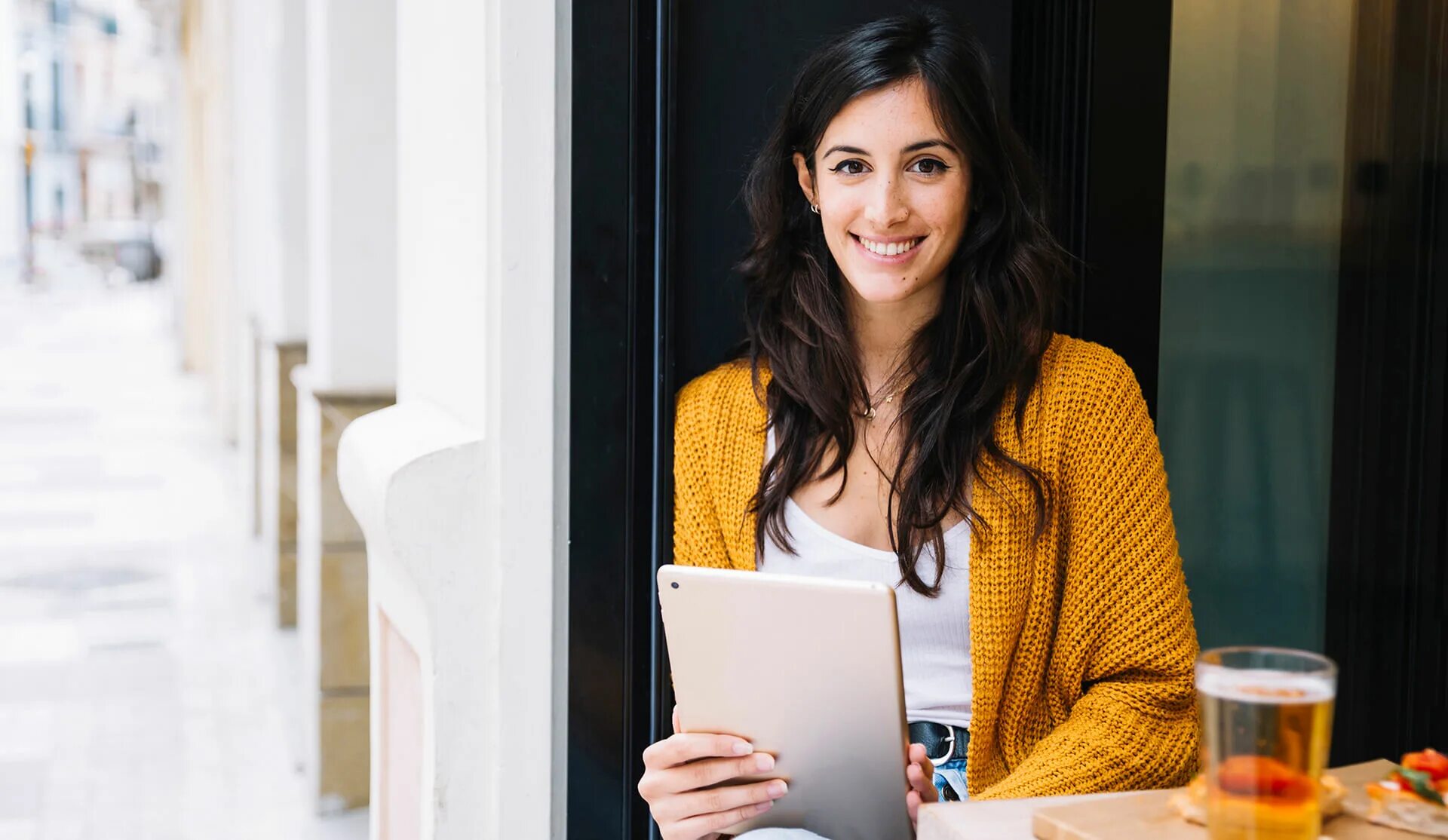 Hispanic woman. Page woman. Not confident girl. Young woman Relaxed at Heater with Tablet in hand. Women page