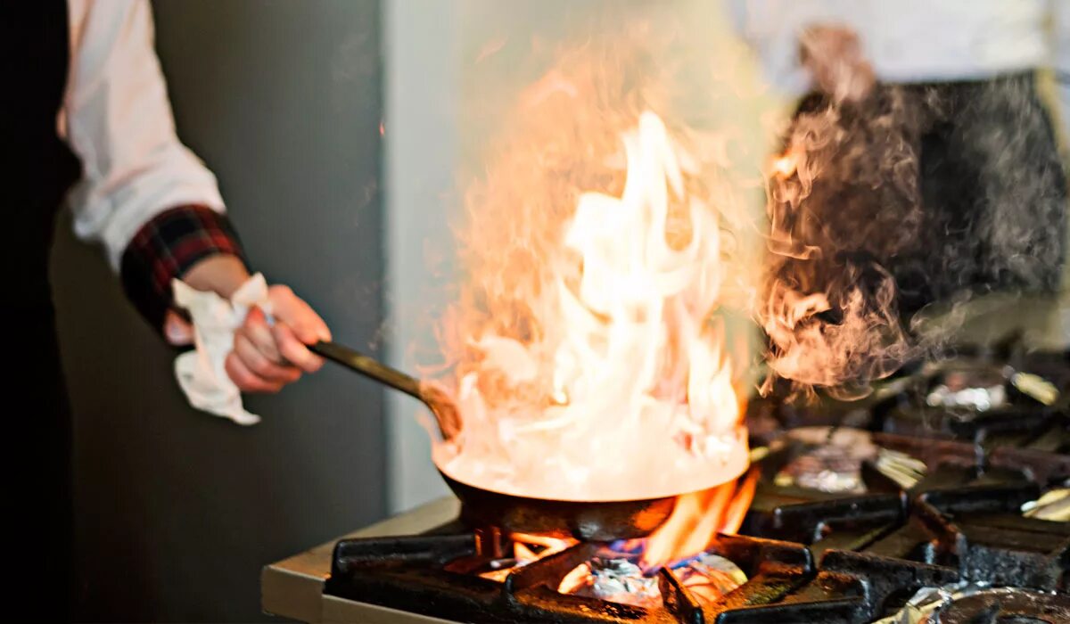 Женщина на кухне. Сковородка горит. Горит сковородка. Загорелась сковорода. Горящее масло.