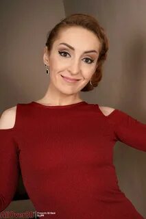 Over 30 redhead Di Devi removes a red dress while stripping to her stockings - f