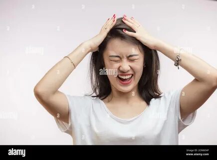 Close up isolated portrait of young extremely upset and frustrated Asian wo...