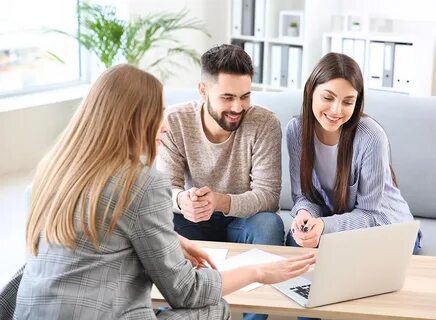 Young couple in office of real estate agent 