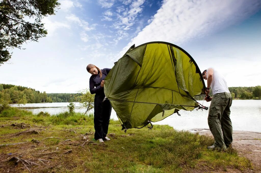 Set up a Tent. Put up a Tent. Тент на природе фото.