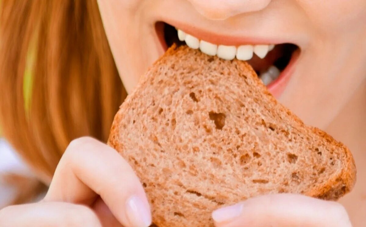 Человек есть хлеб. Девушка ест хлеб. Человек ест хлеб. Покусанный хлеб. Поедание хлеба.