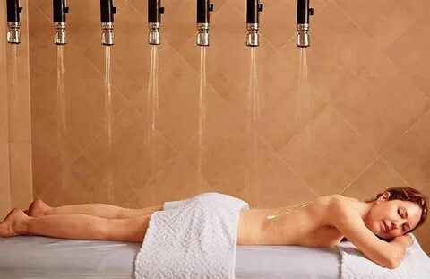 Woman on a massage table getting hydrotherapy.