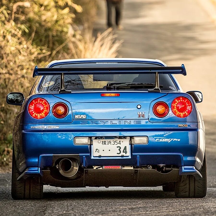 Ниссан скайлайн 34 сзади. Nissan skyline gtr r34. Nissan gtr r34. Nissan skyline gtr r34. Nissan skyline r34 gtr синий.