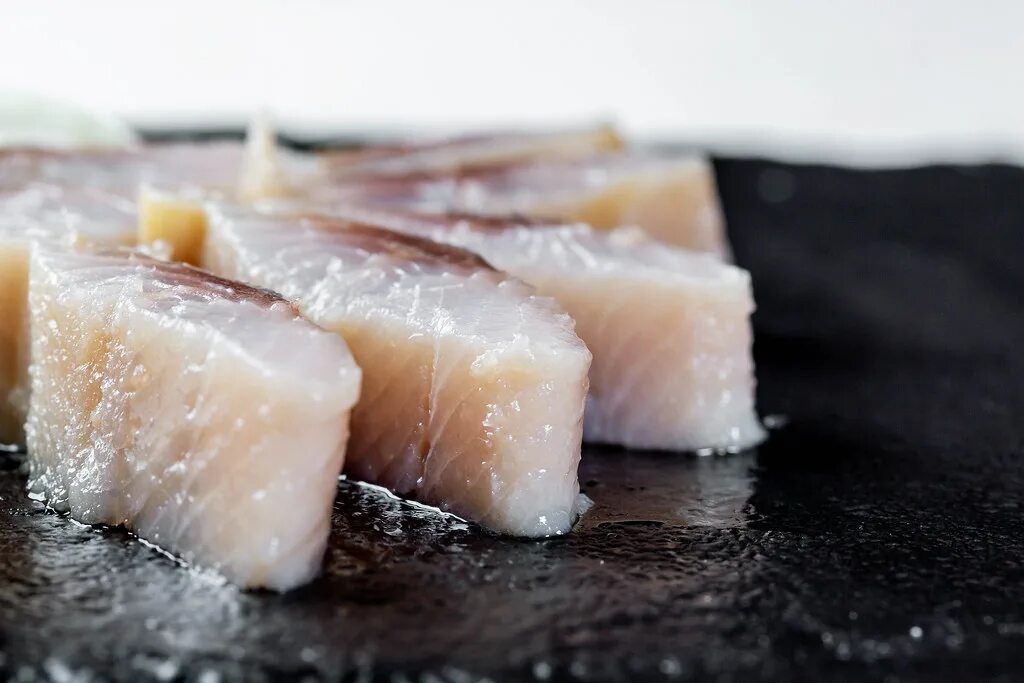 Slice piece. Herring pieces. salted herring top.