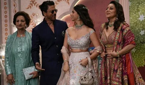 Indian actor Shahrukh Khan, second left, shares a light moment with his fam...