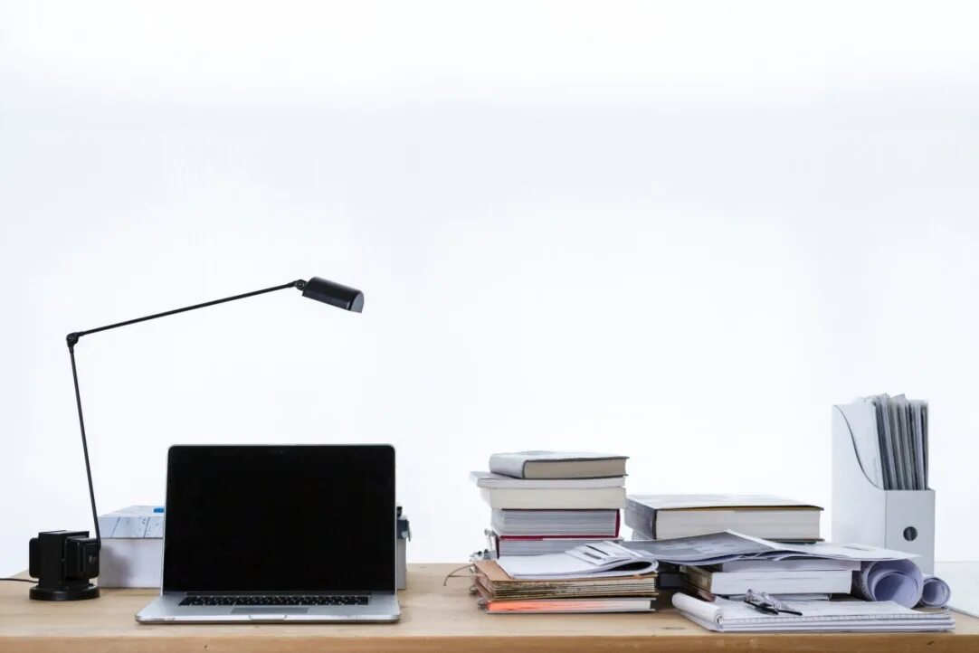 The lamp is on the desk
