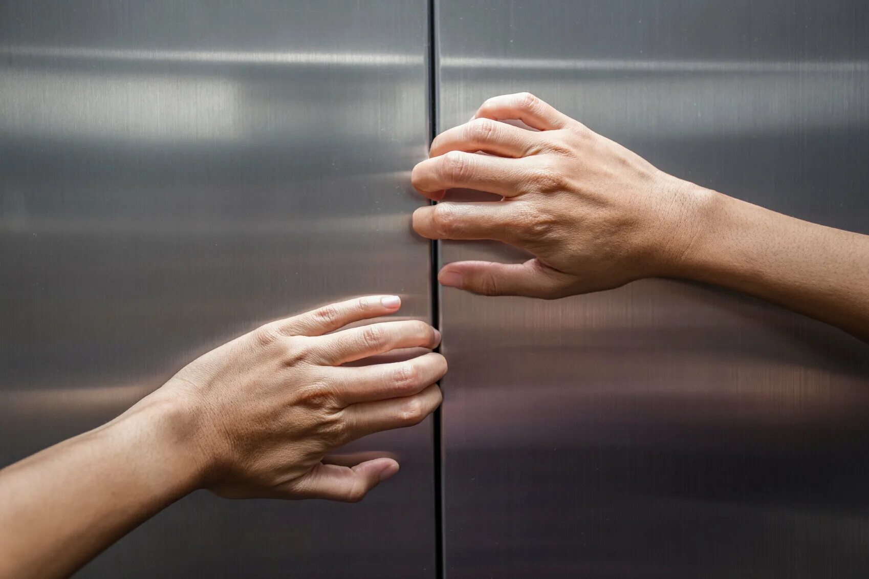 Дверь открывается рукой. Рука на двери. Рука из лифта. Лифт застрял. Рука открывает дверь.