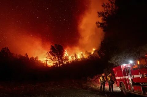 Firefighters watch the Bear Fire approach in Oroville, Calif., on Wednesday...