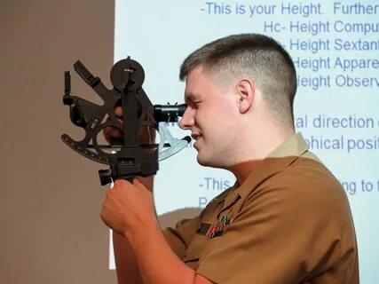 Daniel Stayton demonstrates how to use a sextant before a class of midshipm...