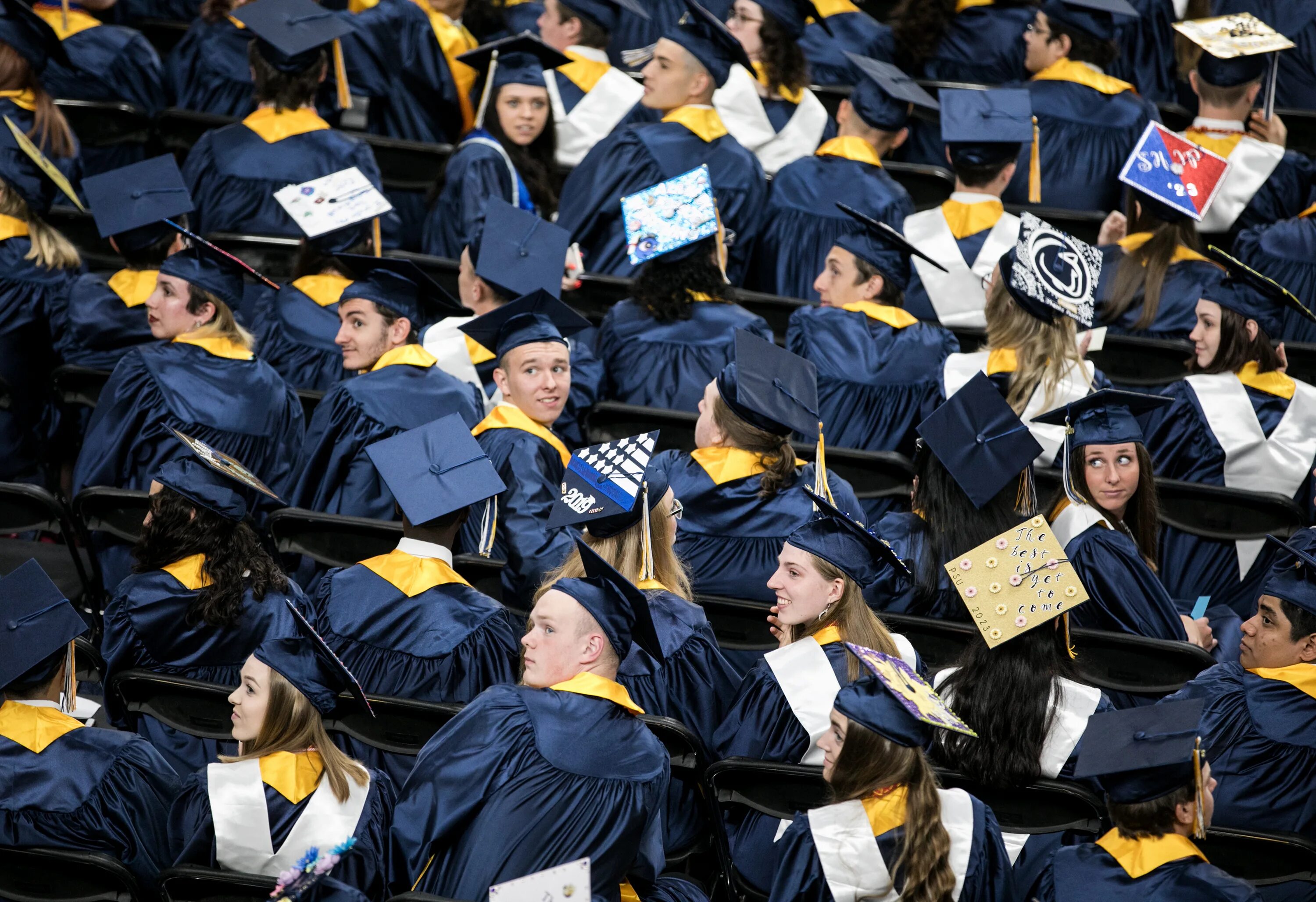 High school graduates. School Graduation. High School Graduation Day. Graduation Party at School. Row of students at Graduation.