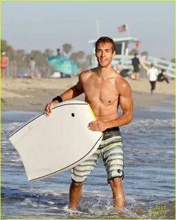 Shirtless Austin North Gets Wiped Out by Waves While Boogie Boarding.