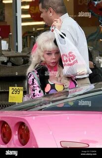 Angelyne leaves Longs Drugs in Beverly Hills in a pink Pontiac Firebird.