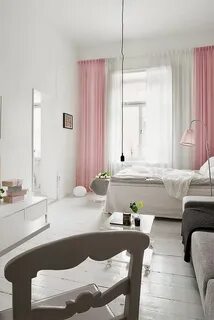 a white room with pink curtains and furniture 