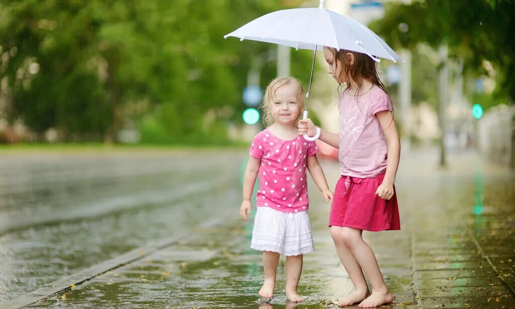 Couples hold Umbrellas in Sunny weather. Rain sisters