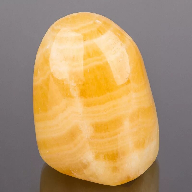 Кальцит магические свойства. Yellow Calcite камень. Желтый кальцит минерал камни. Оранжевый кальцит минерал. Оранжевый кальцит камень.