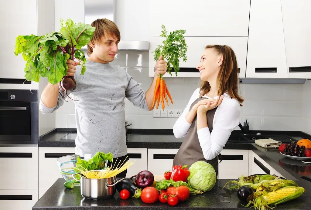Мужчина и женщина на кухне. Люди на кухне. Человек готовит. Фотосессия с овощами на кухне.