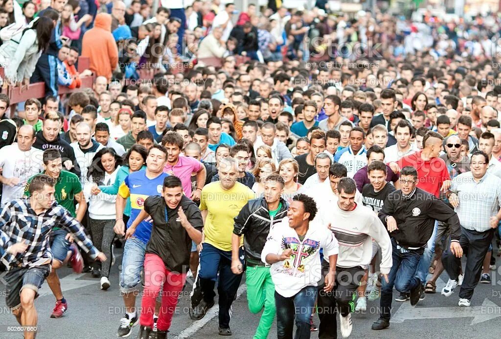 Бегущая толпа людей. Несколько человек бегут. Беговой марафон. Бег в группе. Много людей бежит.