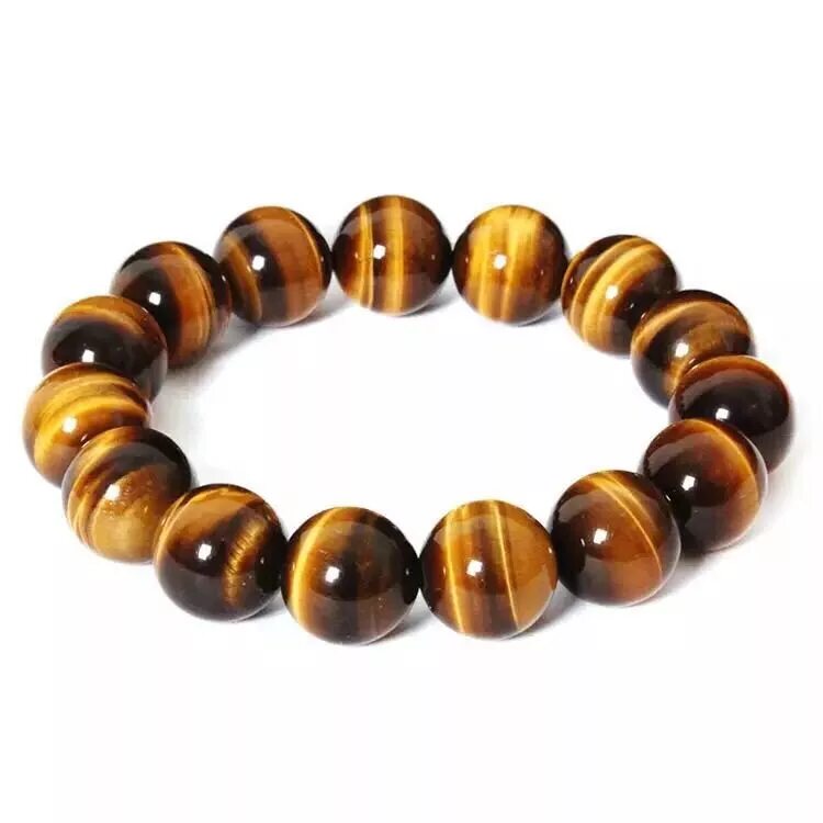 Тигровый камень купить. Yellow Tiger Eye камень. Браслет из тигрового глаза. Браслет из тигрового глаза женский. Тигровый глаз камень браслет.