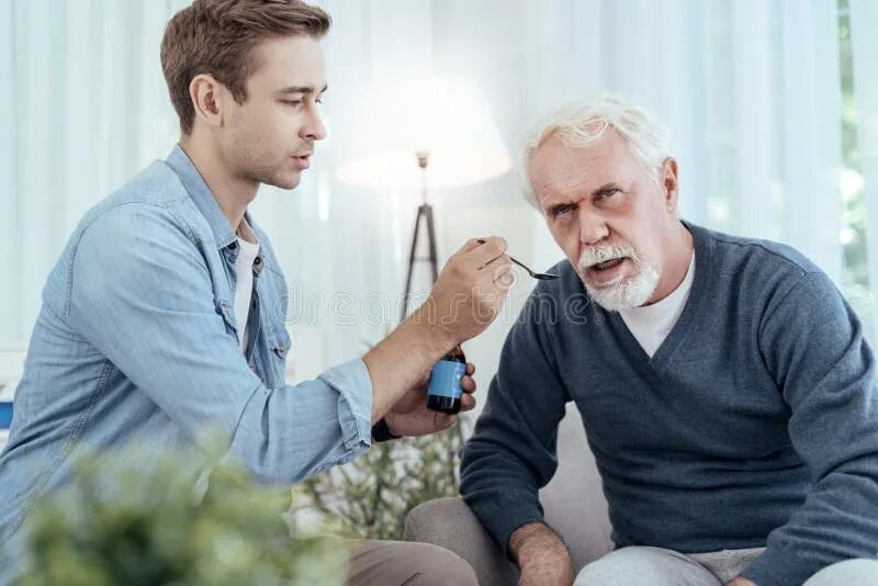 Man holding Spoon. Medication Spoon. Дедушка дает деньги