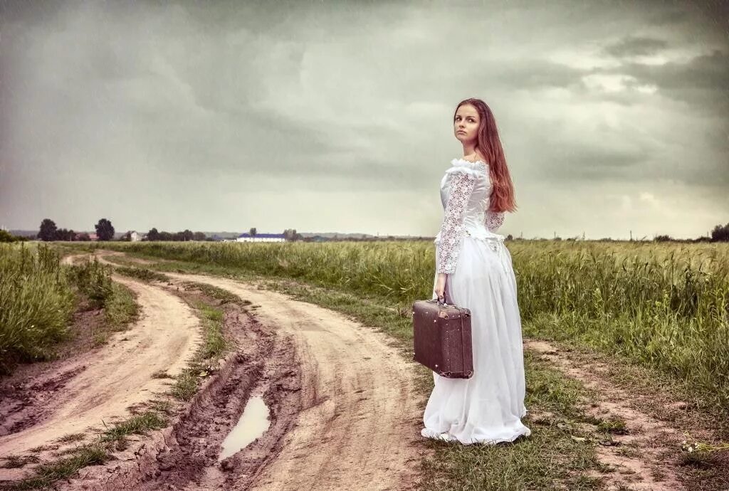 Фотосессию в поле со старым чемоданом. Чемоданы для невесты. Невеста идет по дороге. Фото невесты на дороге.