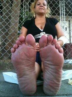 SOLES of Feet side by side.