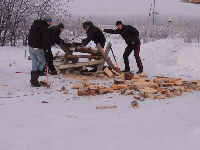 Заготовка дров зимой. Колет дрова. Пилить дрова зимой. Заготовка древесины. Пилят двуручной пилой.