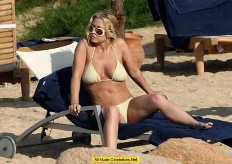 Anastacia sunbathing in yellow bikini in Porto Cervo.