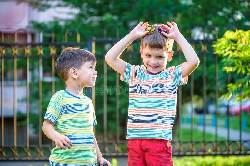 Play span. Two boys playing. Playing with a Spinner for children. Kids playing Spinner.