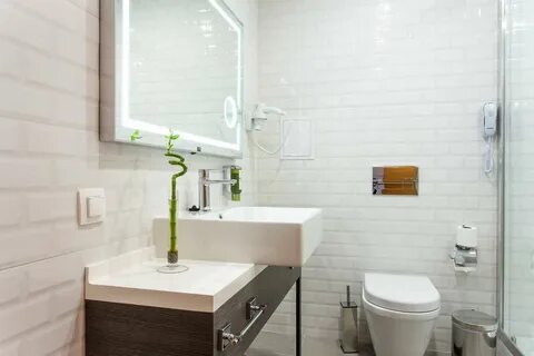 The bathrooms is modernly furnished, with a shower cabin, a mirror with LED...