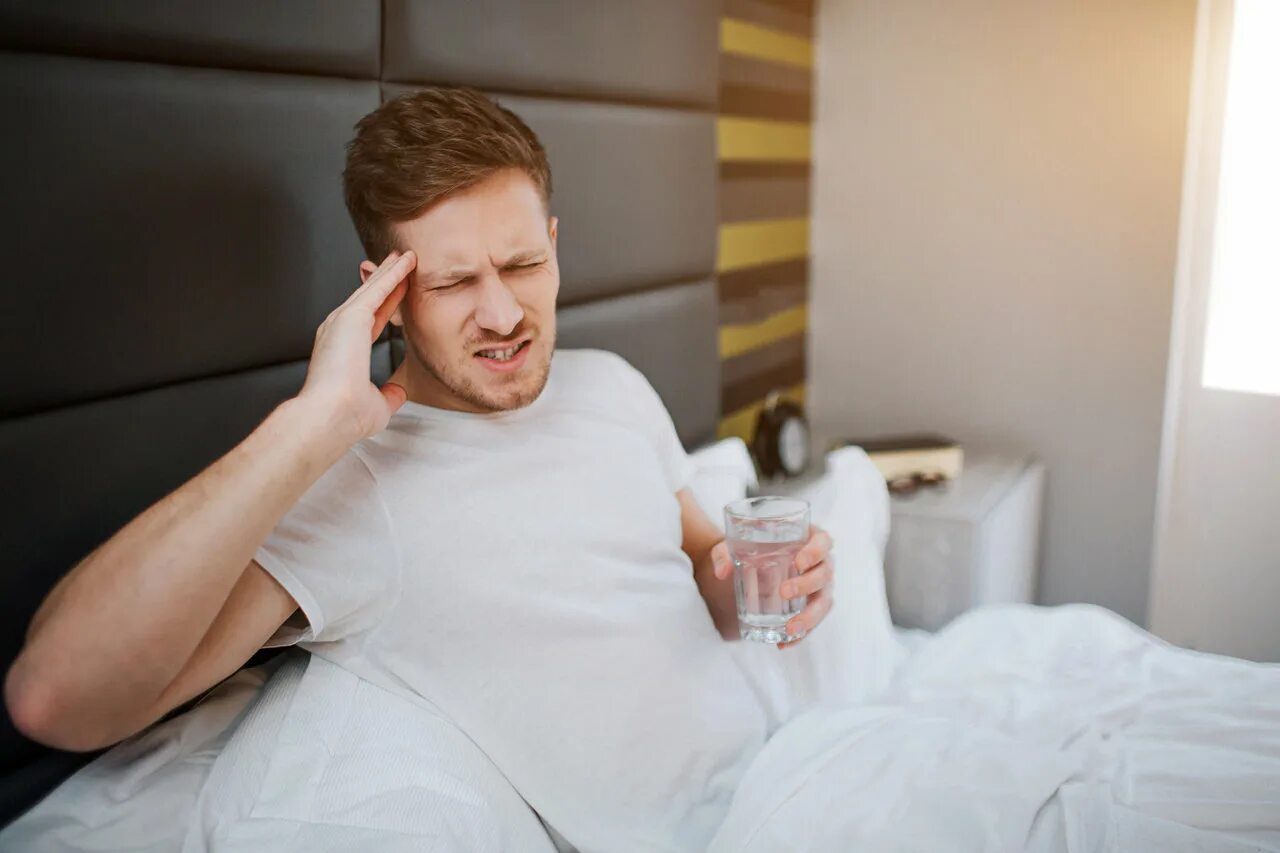 He is having a headache. He has a headache. hangover at morning. he has headache in job. he has headache because he havent breakfast.