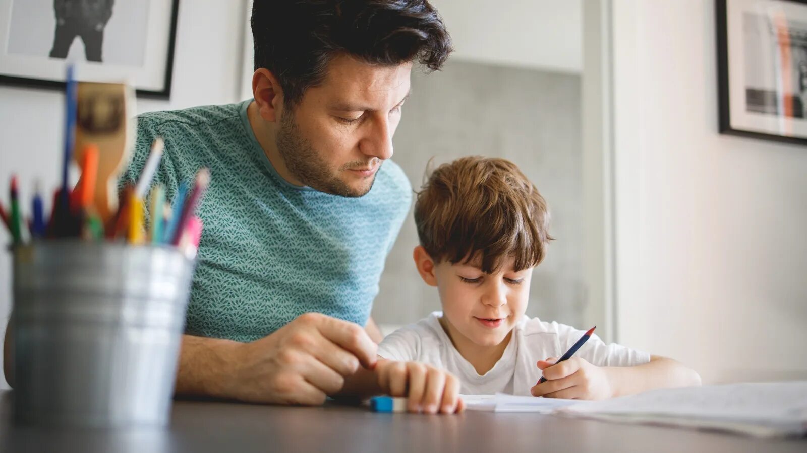 Dad and son do homework. While father watch TV the children do homework. Homework real. Do homework and help mum about the House. Does your son