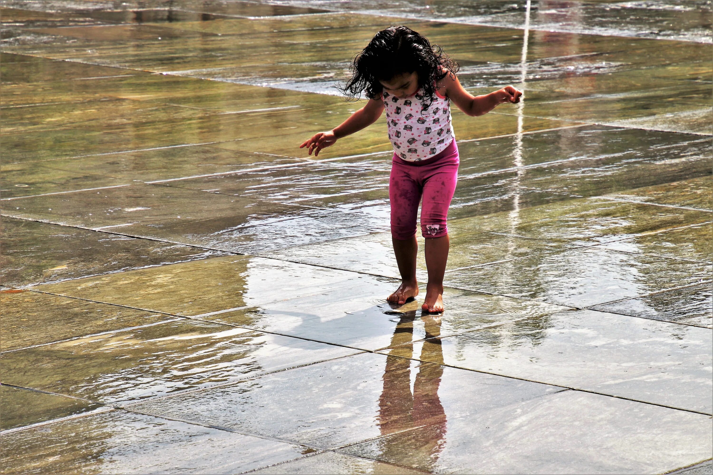 Купаться под дождем. Дети в мокрой одежде. Ребенок промок. Дети брызгаются водой.