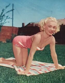 Mamie Van Doren on the grass.