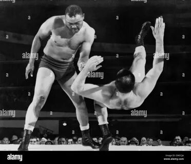 Joe Louis throws Jim Bernard to the mat during a 1956 wrestling match at Ol...