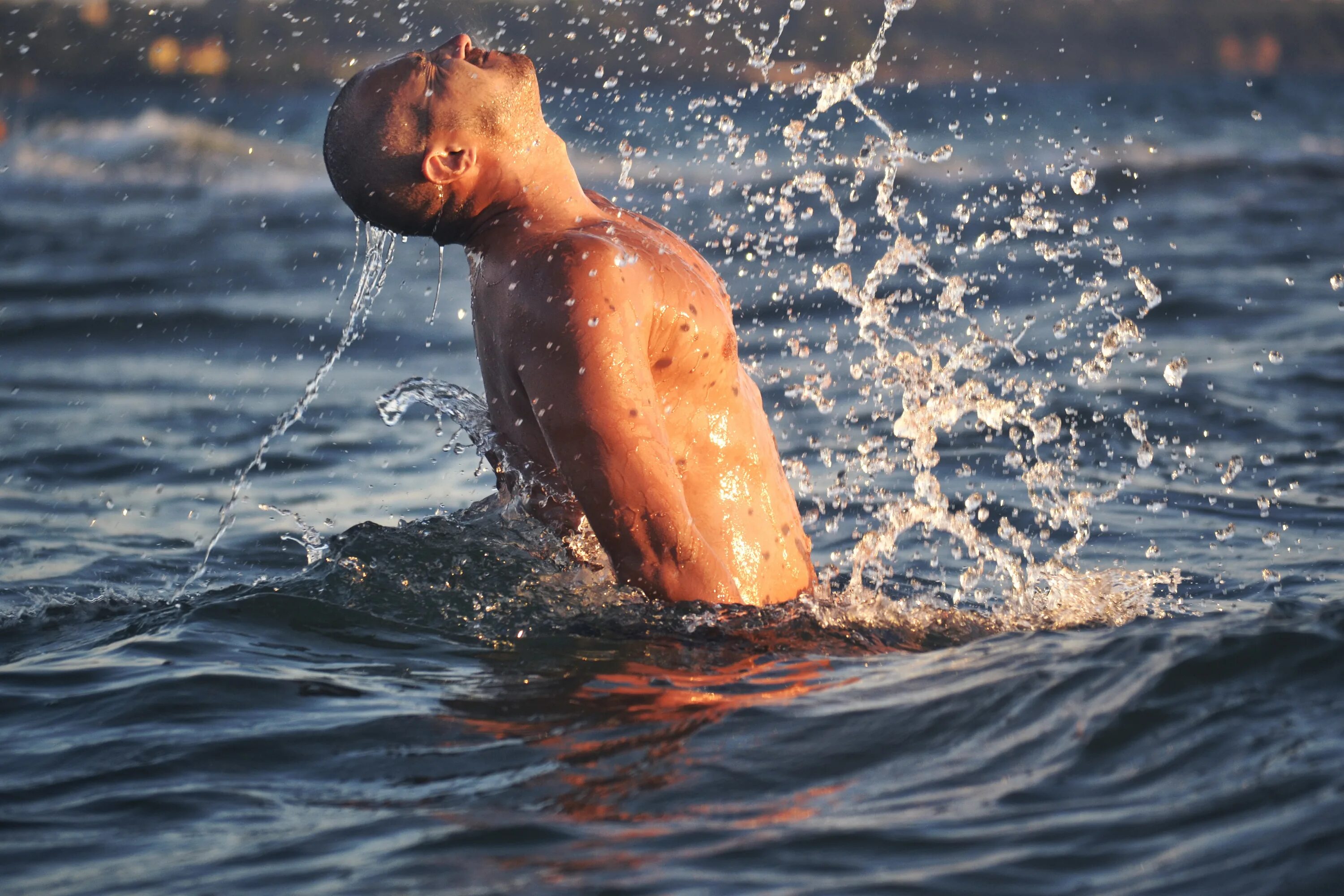 Красивый парень в воде. Вода и человек. Выныривает из воды. Мужчина выныривает из воды. Парень купается в море.