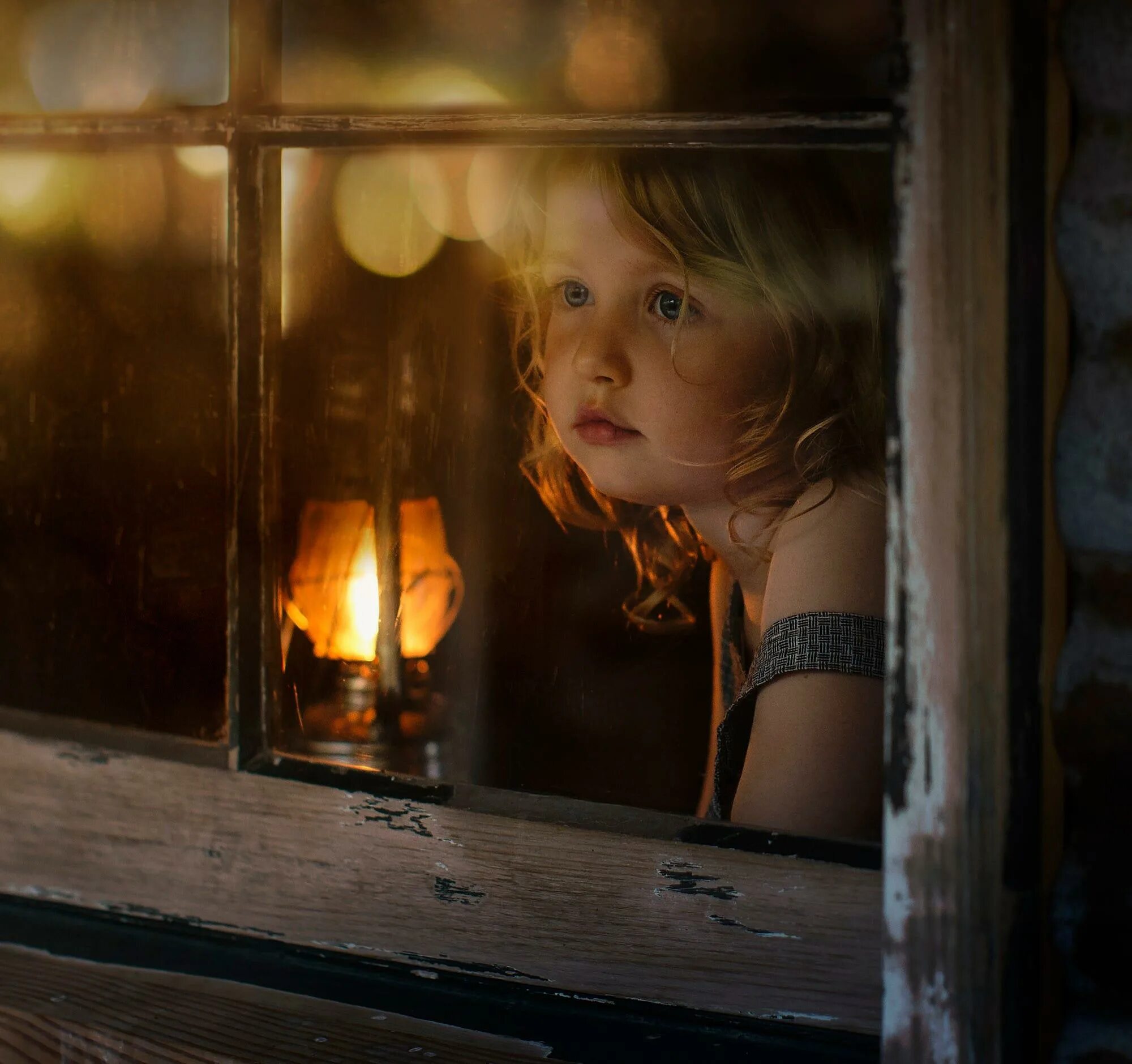 за окошком девочка в бежевом. елена шумилова дети. маленькая девочка сидит у окна. девушка в свете окна. девочка смотрит.