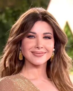 Nancy Ajram complemented her figure-hugging gold gown with earthy makeup.