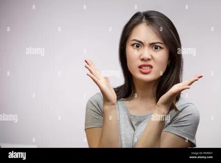 Frustrated Angry Asian woman isolated over white background. 