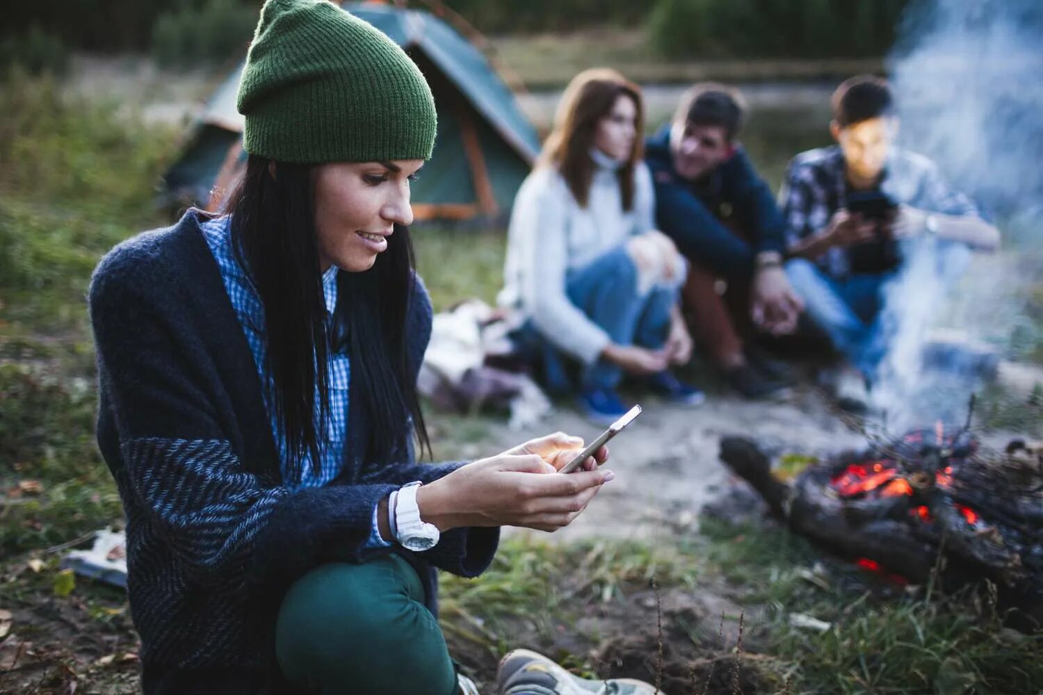 He is at camp. Camping Play mobile Phone. Using mobile while.