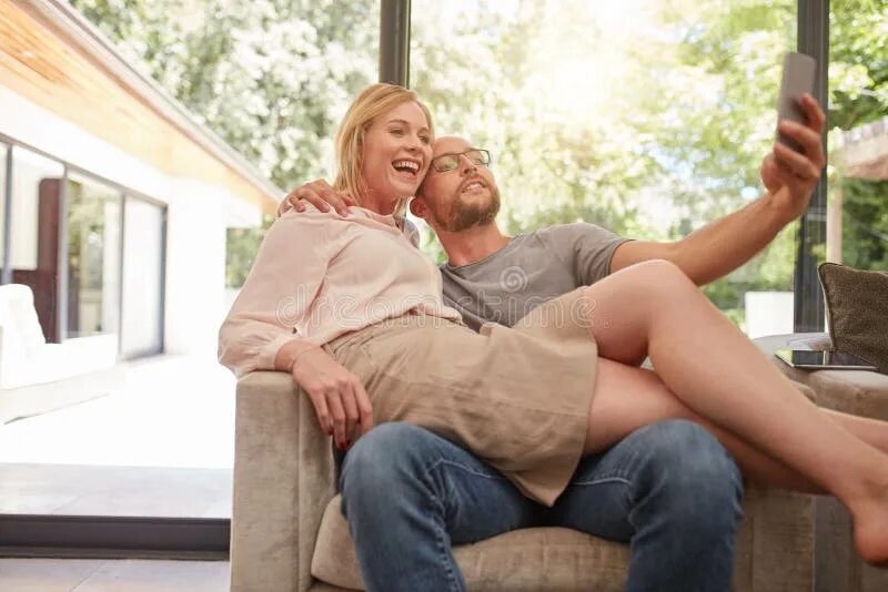 Woman sitting on lap. Woman sitting on man's lap. Sitting on her lap. Woman sits on lap.