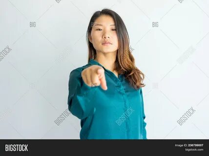 Serious Confident Young Asian Woman Pointing At You. 