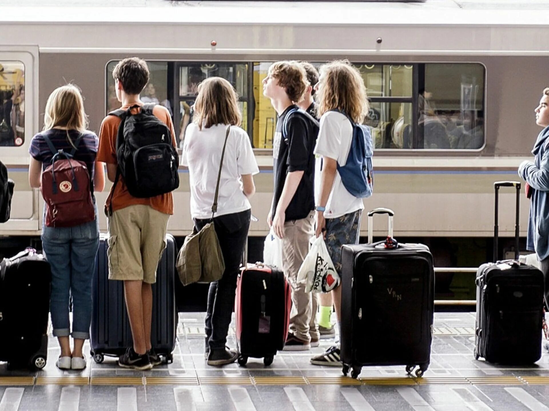 уезжаю учиться в другой. студенты со спины. эмиграция. уезжаю учиться в другой. человек уходит с чемоданом.