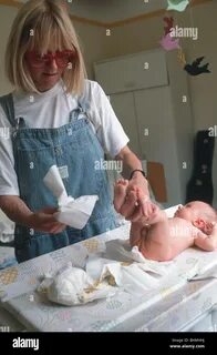 UK MOTHER CHANGING NAPPY TO BABY Stock Photo Alamy.