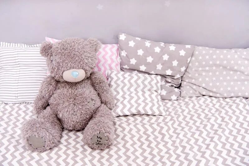 The teddy is on the bed