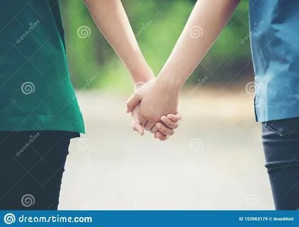 Two asian woman holding hands and moving foward.