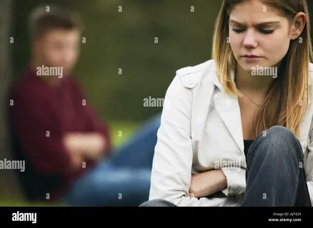 Profile of a brother and his sister facing each other Stock Photo. 