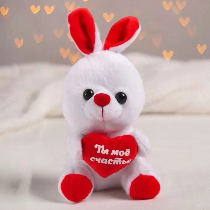 Заяц игрушка с сердечком. Мягкая игрушка зайчик с сердечком. Мягкая игрушка "счастья". Мягкие игрушки на 14 февраля.