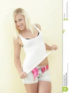 Woman removing her clothes stock photo. 